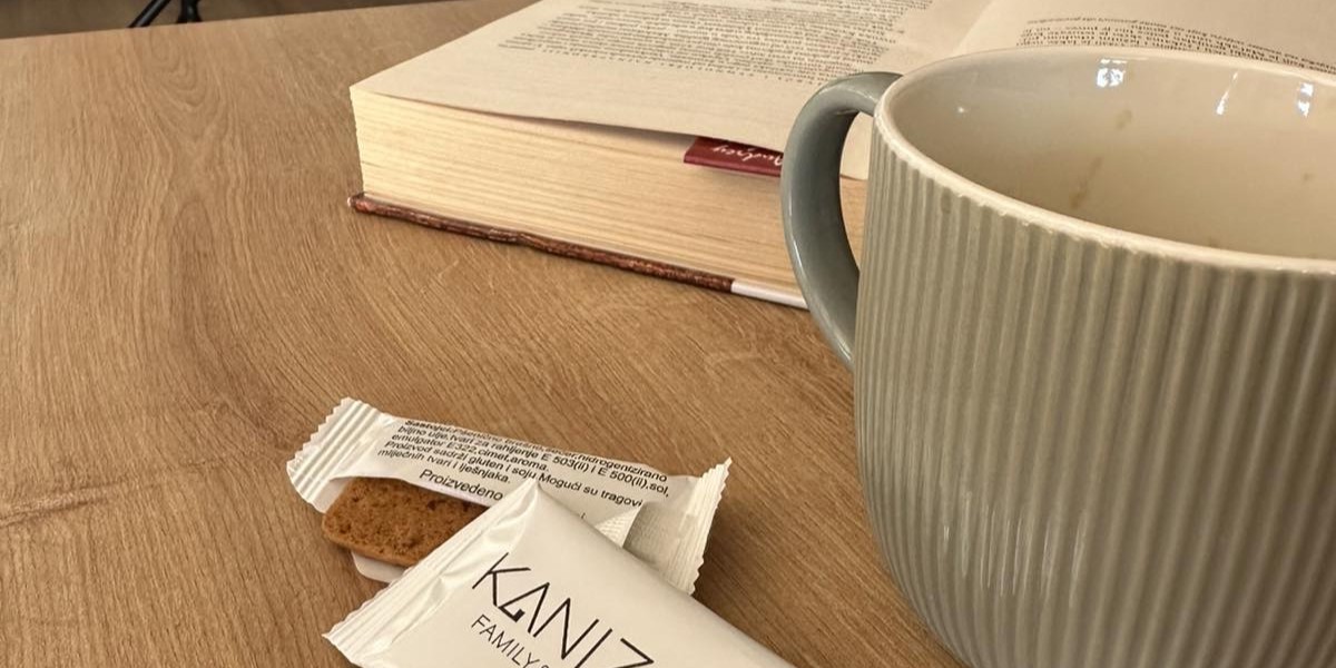 Open book and a cup of tea at House KANIZSAY on a rainy afternoon.